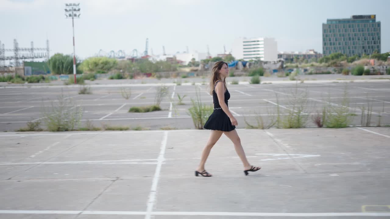 Woman Walking in an Urban Parking Lot