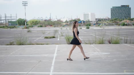 woman walking in an urban parking lot