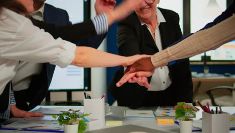 close up of happy creative multiethnic business team celebrating successful project