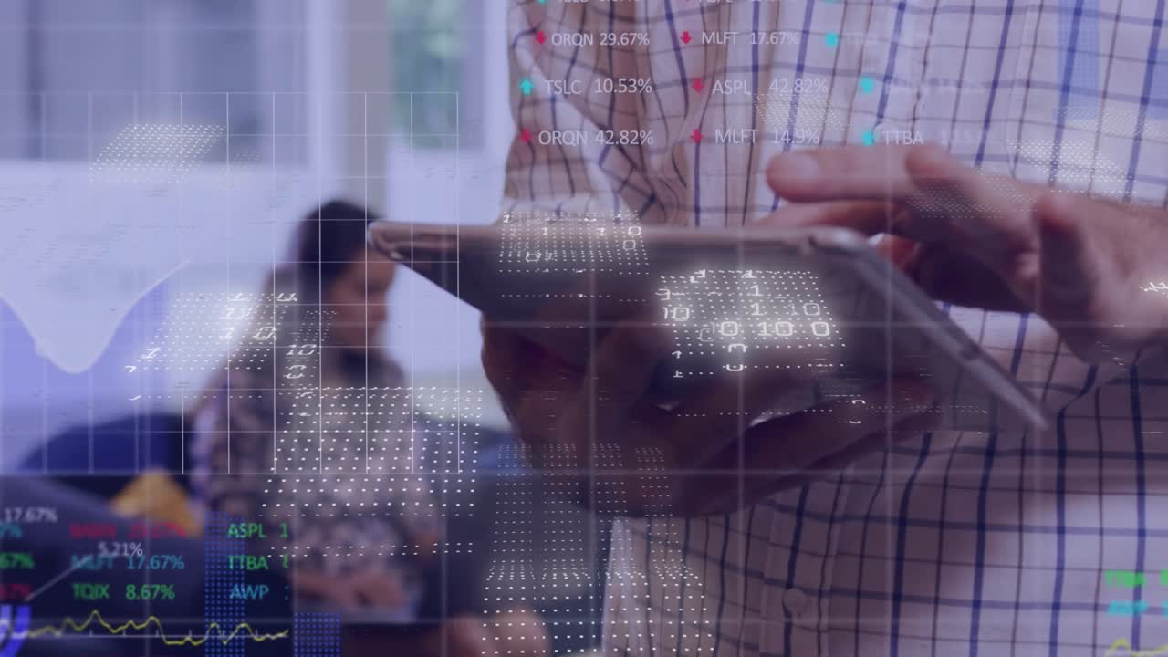 Mid adult man tapping tablet and generating financial data overlays while comparing market readings