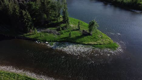 Aerial-Exploration-of-a-Serene-River-and-Its-Flourishing-Green-Landscape,-Canada