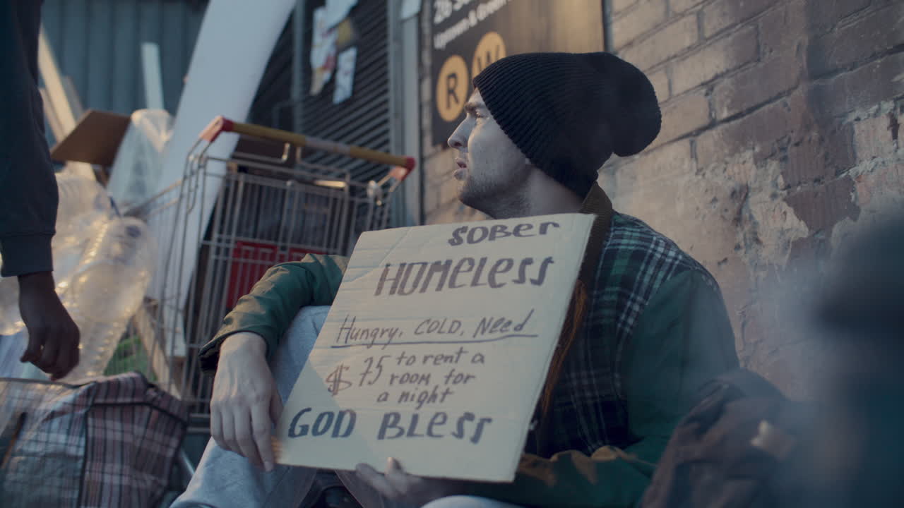 Young Homeless Man Begging for Money near Subway Entrance