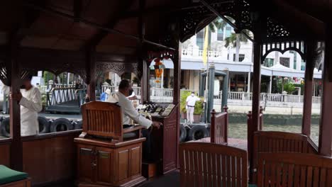 man playing organ in a riverside gazebo