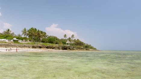 villagers at the tropical coastline on the indian ocean in diani beach, kenya, africa