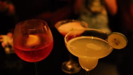 friends clinking glasses in a lively bar