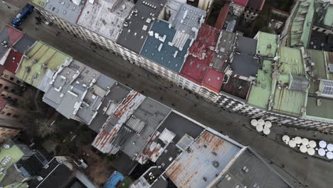 Drone-top-view-of-buildings-rooftops-and-streets-in-city-center-Krakow,-Poland