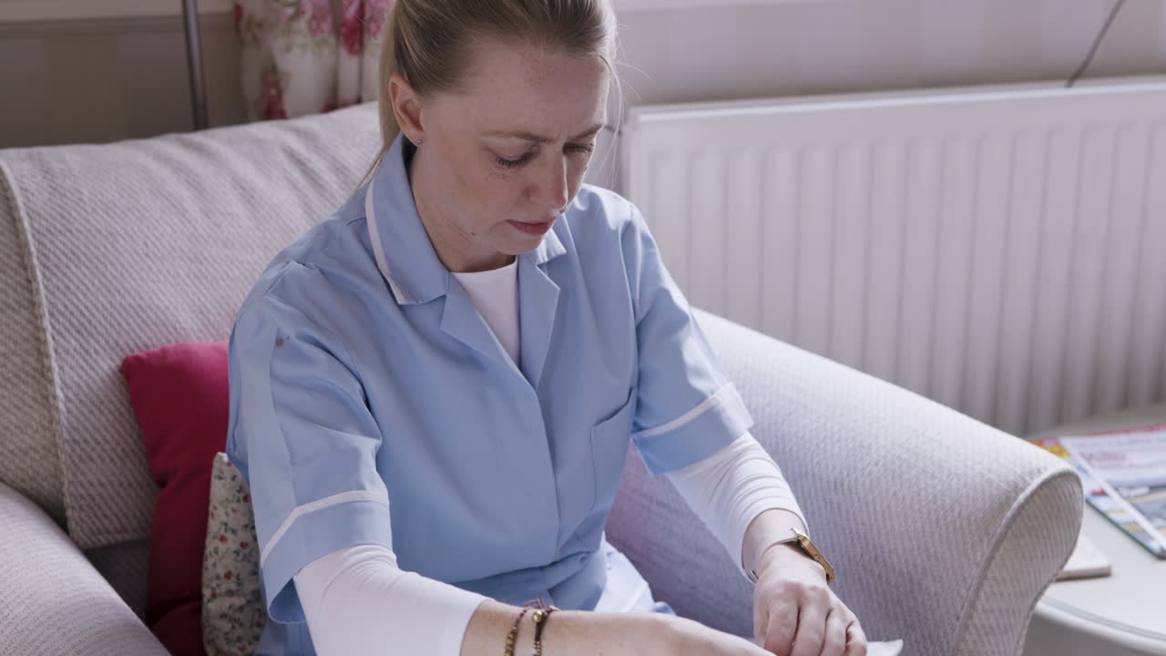 A nurse reading a document at home