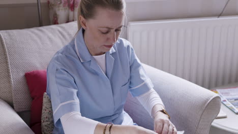 a nurse reading a document at home