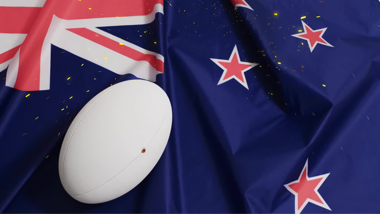 animación de confeti sobre una pelota blanca de rugby y la bandera de nueva zelanda