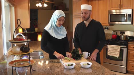 middle eastern young couple make salad she chops static