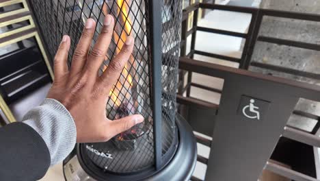 hand near a modern gas heater