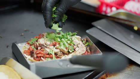 sprinkling cilantro to make a mulita - food truck series