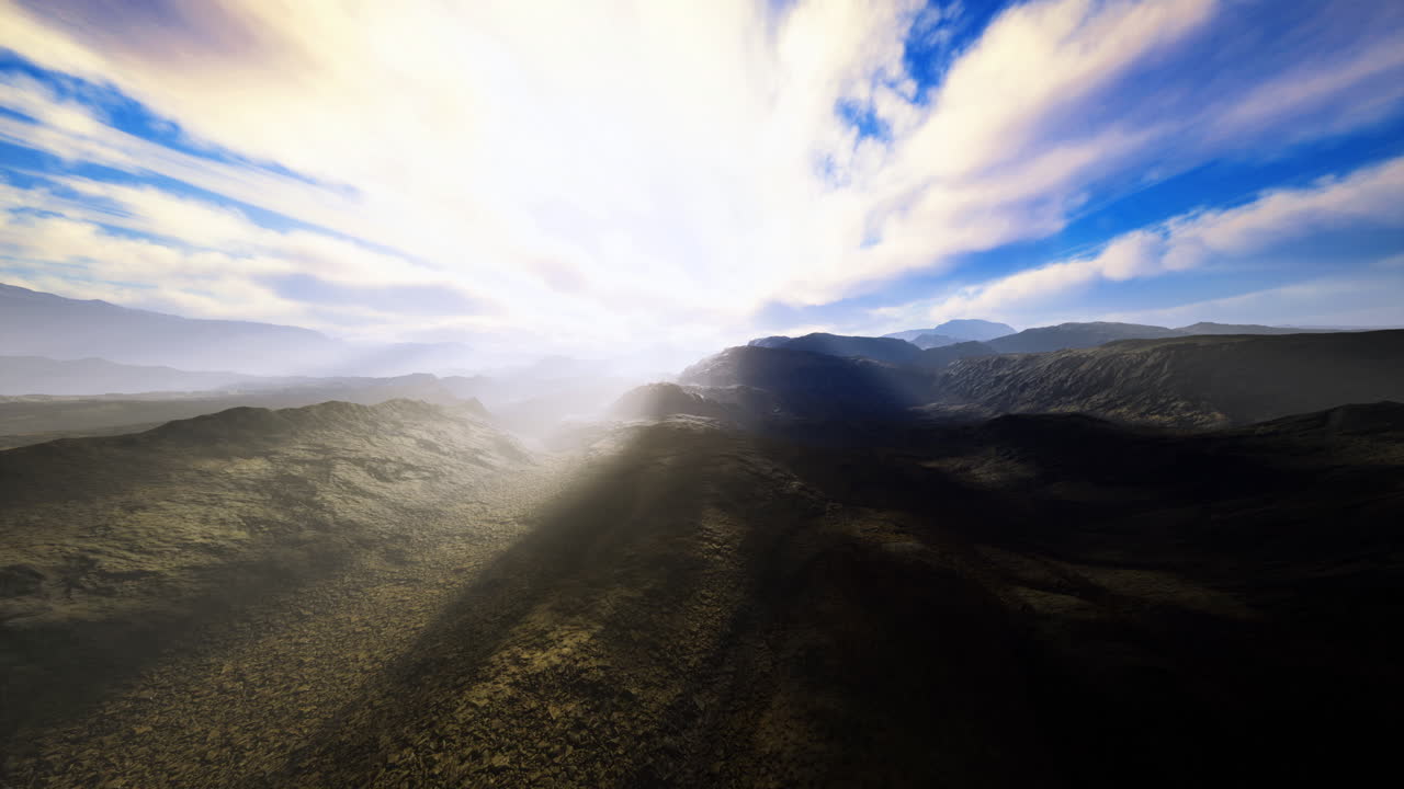 Vibrant sunrise casts light over rugged mountain landscape in early morning
