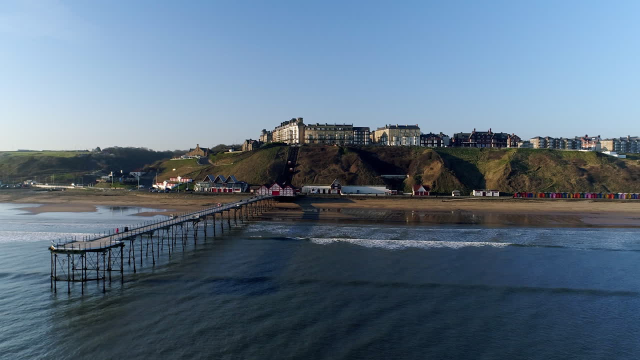 Aerial View of a Seaside Town with Pier and Beach