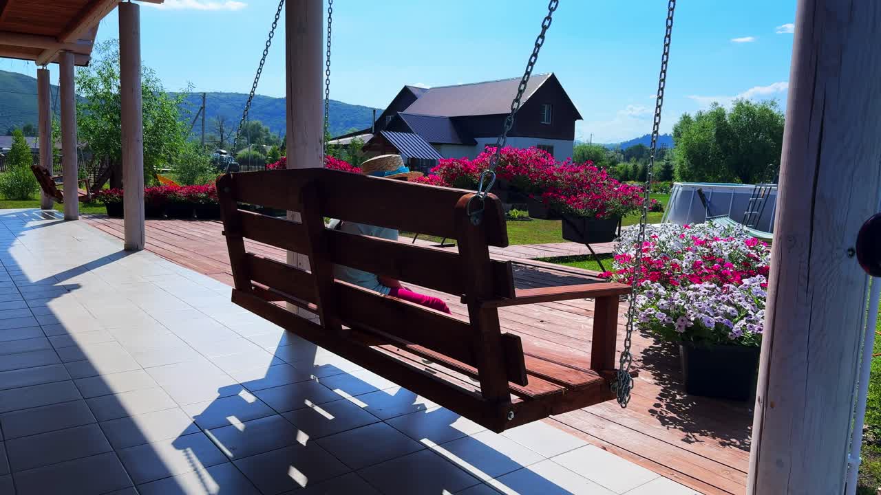 Serene Garden Swing Experience: A Tranquil Retreat Amidst Blooming Flowers and Scenic Views Inviting Relaxation and Reflection