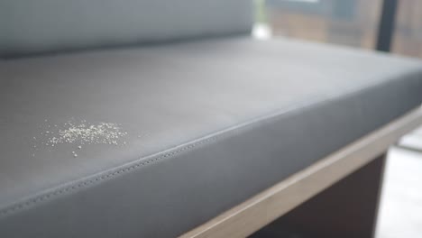 grey leather bench with a dust/stain