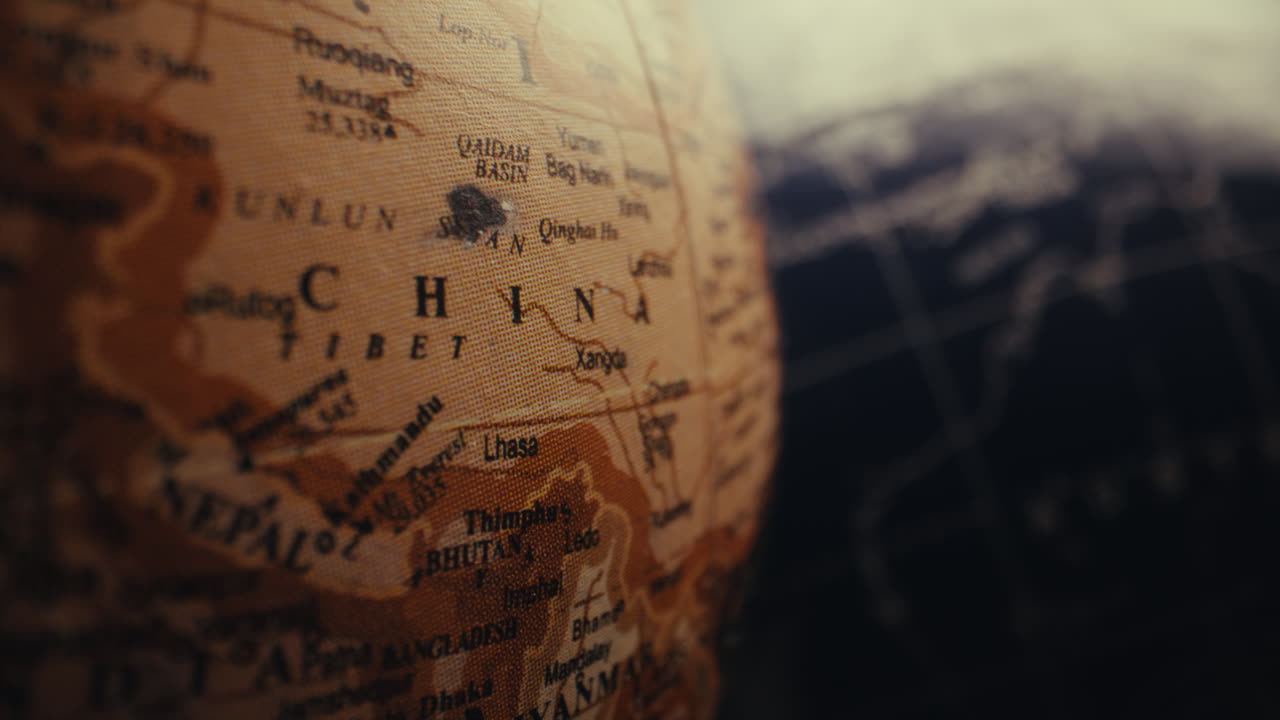 Close-up of a vintage world globe focusing on China and Tibet