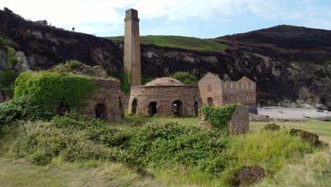 cinematic aerial opening shot of the remains of the porth wen brickworks in anglesey, north wales, europe