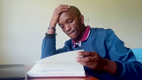 young black africa man reading in the house during ukraine-russia war