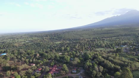 Serene-Loitokitok-village-at-footstep-of-Mount-Kilimanjaro,-Kenya,-aerial-reveal-shot