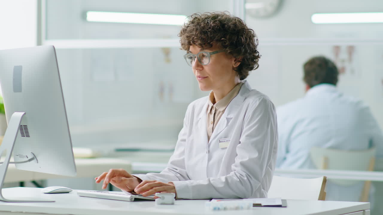 Female Doctor Working on Computer in Clinic