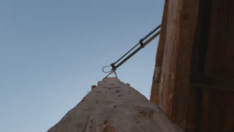 moving heavy wooden plank with crane to load and prepare timber shipment, pov