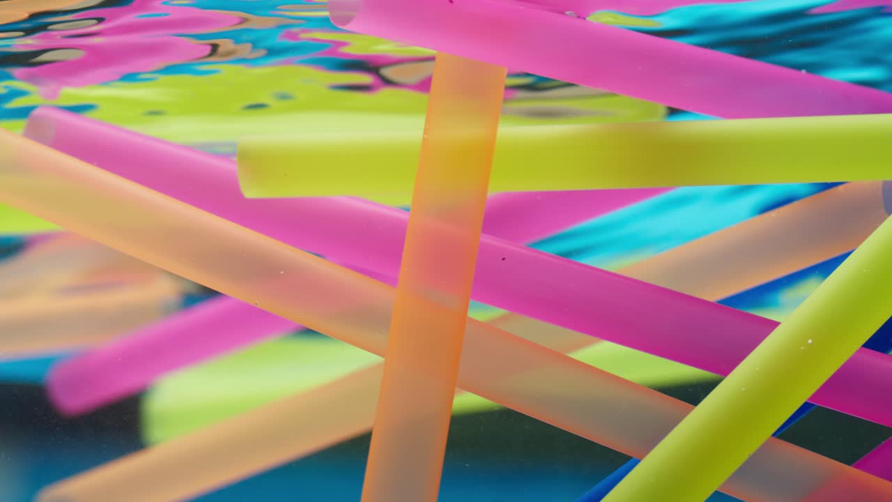 Colorful Plastic Straws Floating in Water