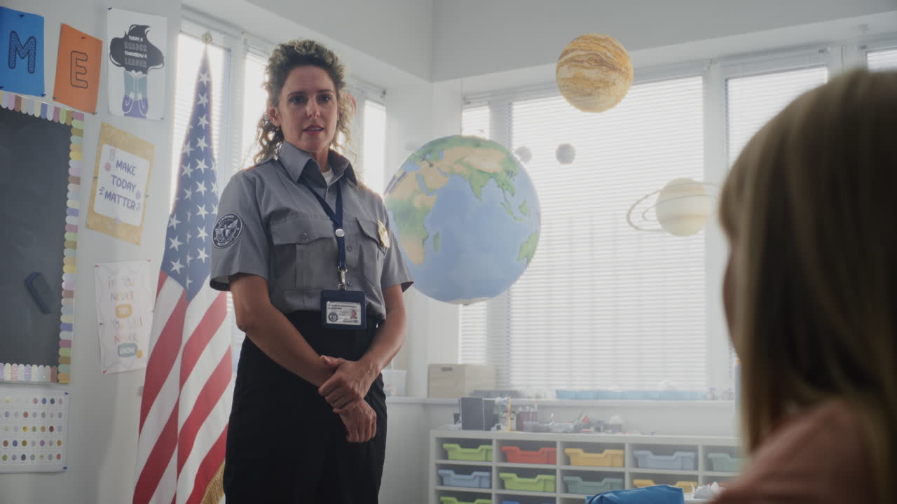 American Female TSA Security Officer Explaining Safety Rules to Young Students at Elementary School