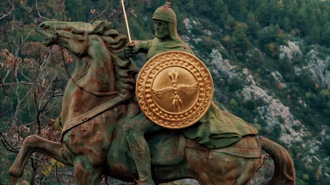 Eze, France - November 24, 2024: Bronze warrior statue at the top of a hill