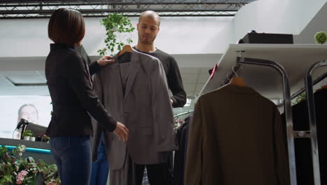 customer trying on suits in a clothing store