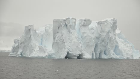 Stabilized-shot-around-huge-ice-berg-in-ocean