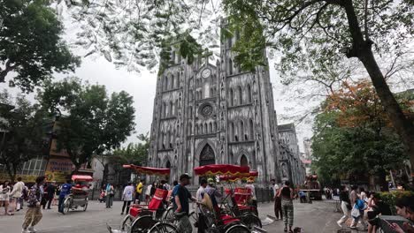 busy street scene with cathedral and rickshaws