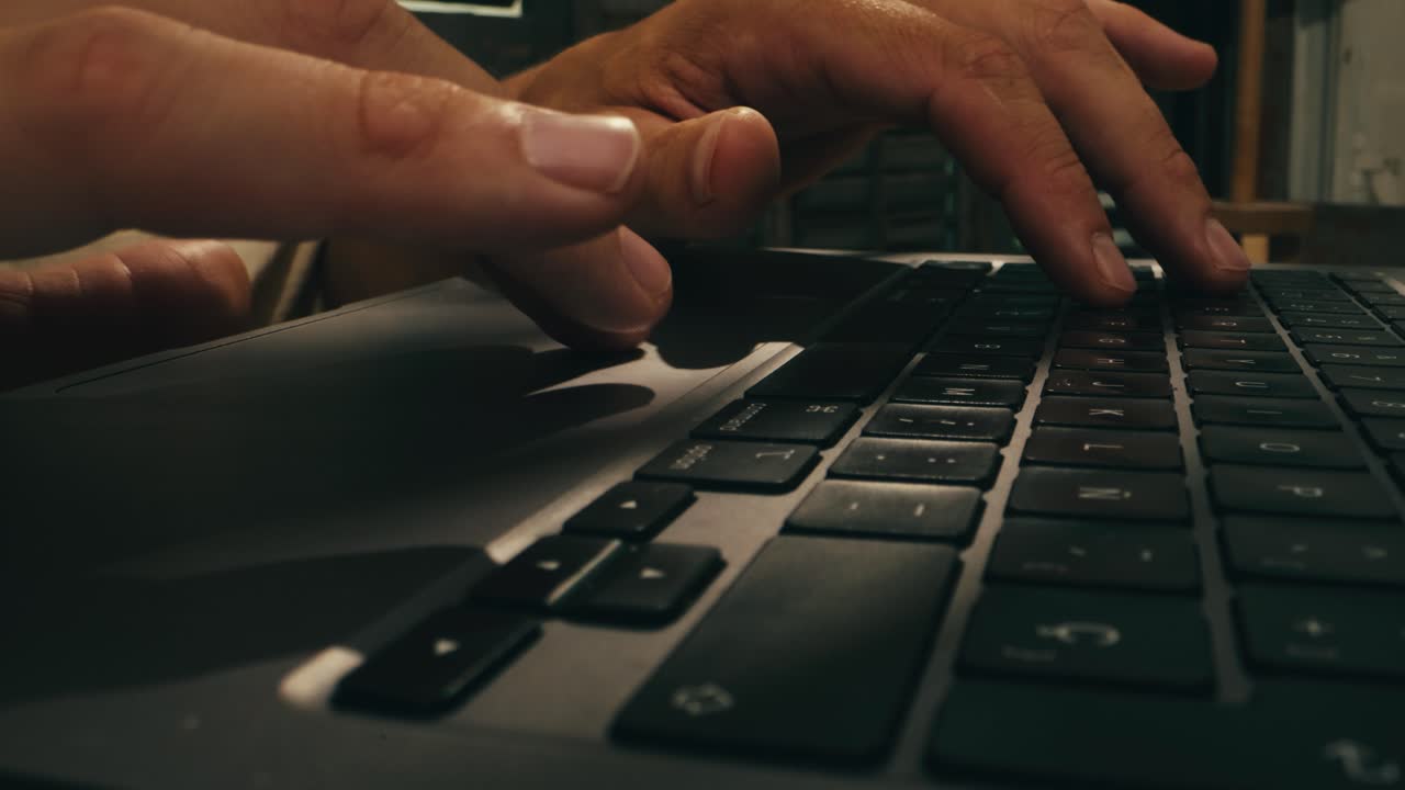 Closeup of hands typing on a laptop, showcasing productivity and advanced technology in a modern workspace