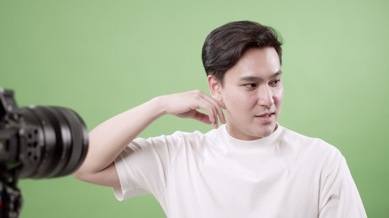 A male model showcases dynamic poses in a studio emphasizing creativity against a vibrant green backdrop.