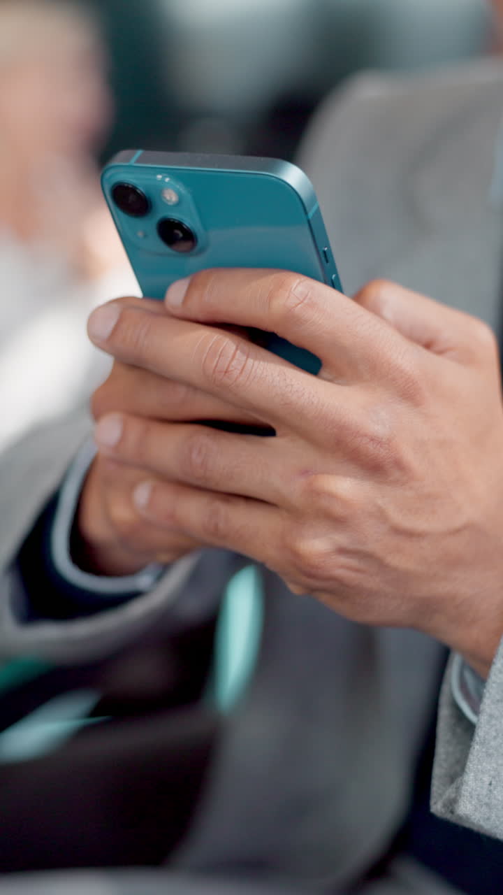 Close-Up of Man's Hands Using a Blue Smartphone
