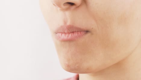 close-up of woman eating black raisins. dried fruits.