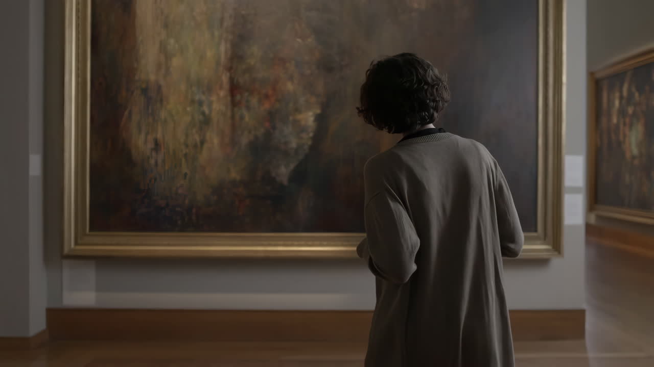 Person viewing a painting in an art gallery