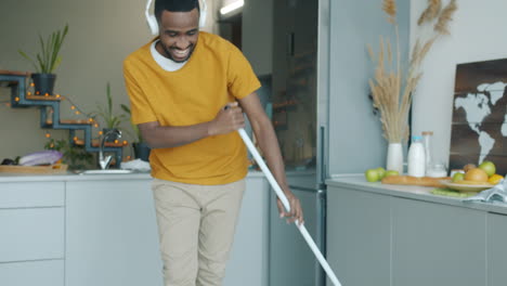 happy man cleaning kitchen