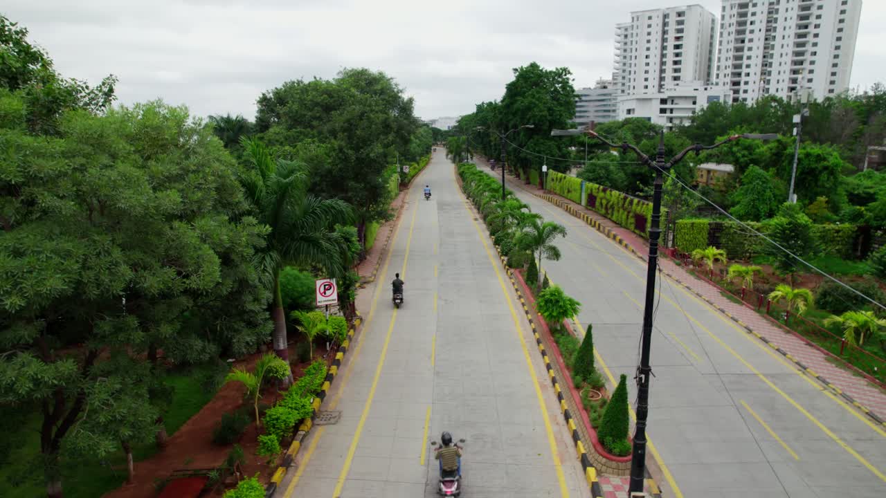 Necklace road with hussain sagar lake and apartments. day time, push in, drone shot, 4k