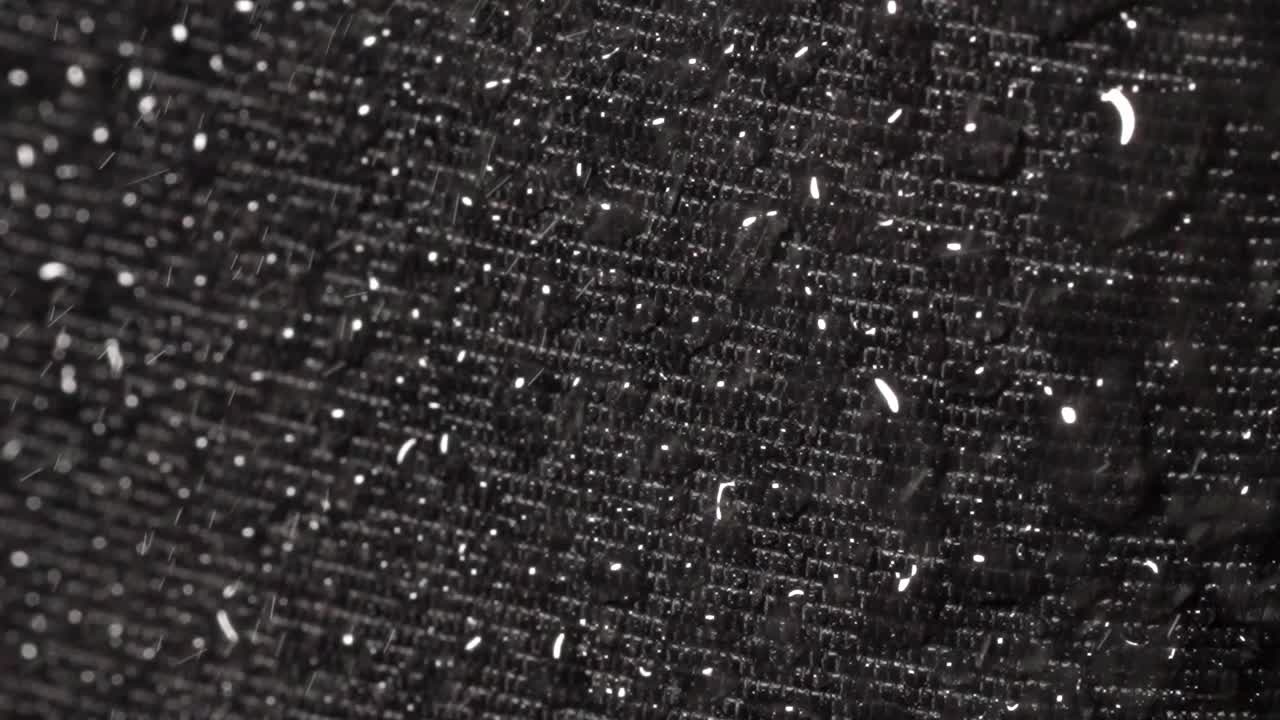 Slow motion macro recording of water drops on lotus-effect surface