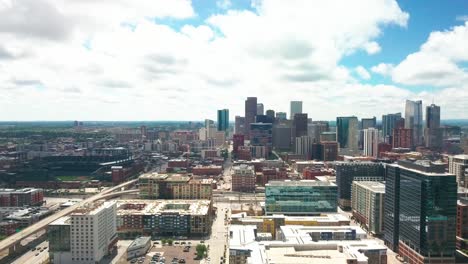 wide aerial drone shot of downtown denver skyline with coors field