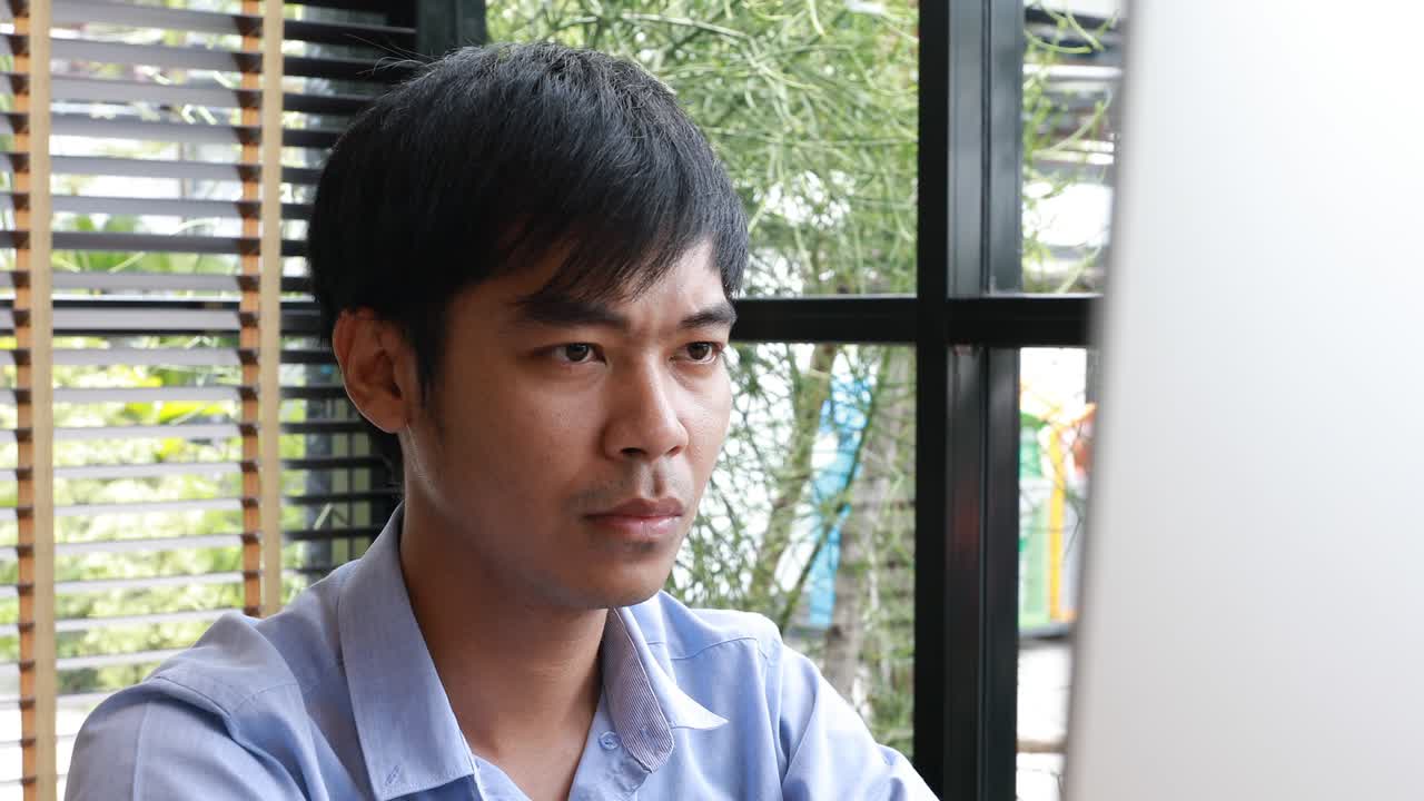 close up smiling asian businessman working in loft office
