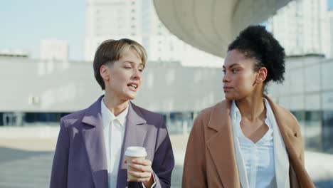 businesswomen talking outdoors