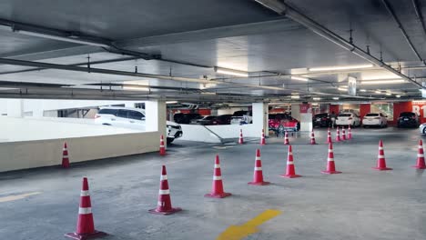 indoor parking garage with empty spots and traffic cones