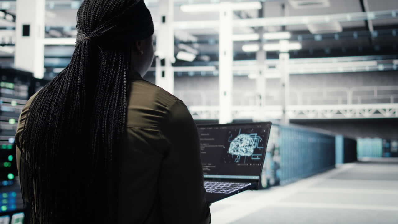 Computer scientist doing data center automation using AI on laptop