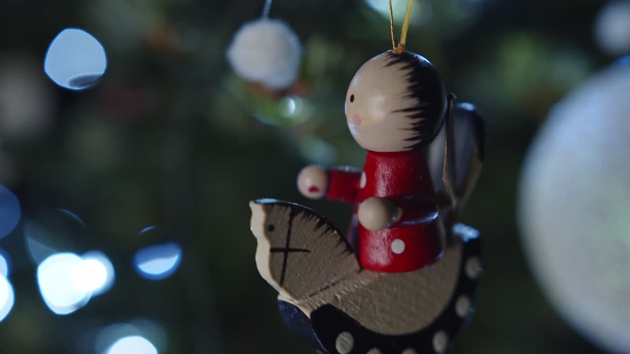 Close-up of a vintage wooden Christmas tree ornament with blurred lights