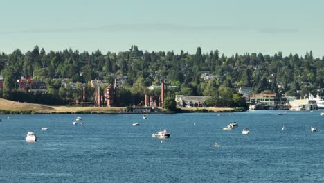 boats floating on lake union with gasworks park in the backdrop