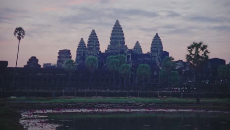 Dawn-breaking-over-Angkor-Wat-silhouette-with-a-vibrant-sky,-timelapse