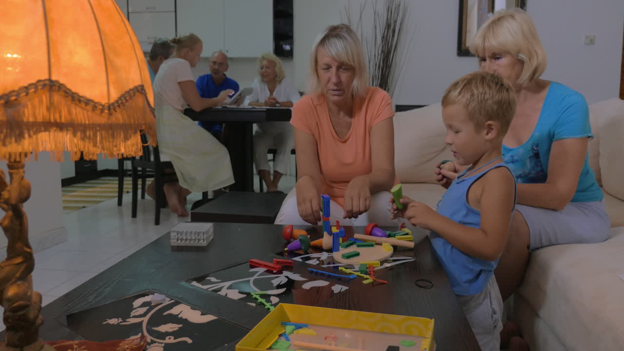 Grandmothers playing with grandson at home
