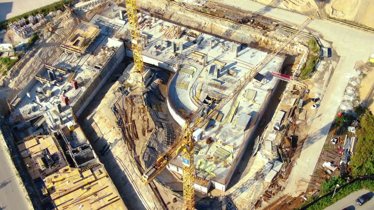 sitio de construcción de edificios altos. gran grúa de torre industrial con cielo azul y paisaje urbano en el fondo. balance de peso de placas de hormigón. contrapeso. vista aérea de drones. desarrollo de la ciudad de la metrópolis